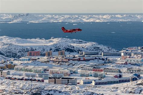 Tourists at Nuuk Airport ready for Arctic expeditions under the midnight sun