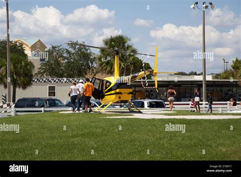 Tourists disembarking helicopter after scenic flight with smiles and excitement