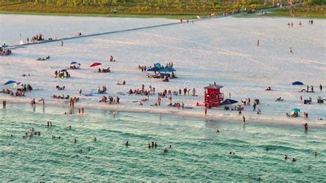 Tourists enjoying morning arrival at Sarasota beach after early flight from Miami