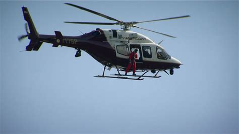 tourists preparing to board air florida helicopter with staff assisting smilingly