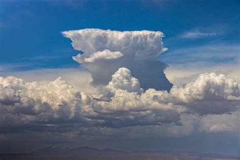 towering cumulonimbus thunderstorm clouds viewed from aircraft cruising altitude