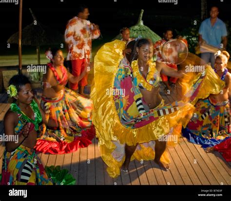 Traditional Mauritian sega performance on a beach resort welcoming European tourists