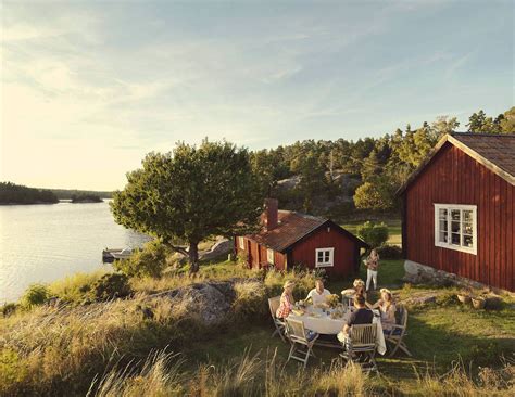 tranquil summer sunset in the Stockholm Archipelago, red cottage by the shore