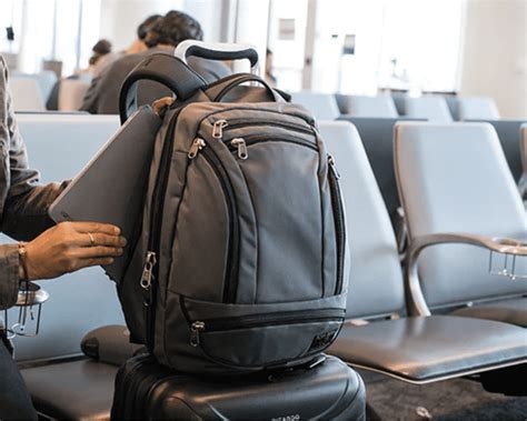 traveler at airport gate with backpack and under-seat personal item