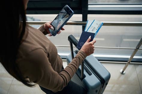 traveler holding smartphone airport security digital privacy concern