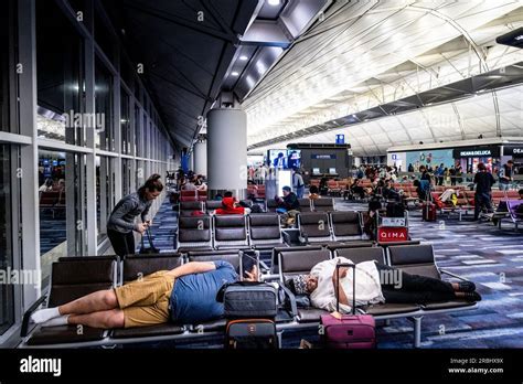 traveler resting with luggage during long layover at international terminal
