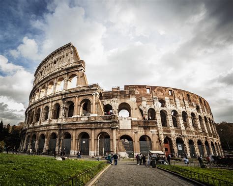 traveler walking out of fiumicino with colosseum image in background, symbolizing arrival in rome