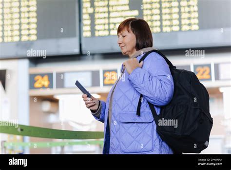 traveler with backpack entering LaGuardia Airport terminal under cloudy sky