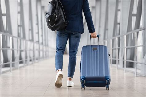 Traveler with carry-on bag waiting near Southwest departure gate for standby clearance
