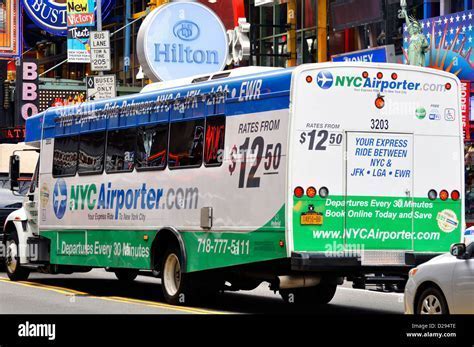 traveler with luggage boarding shuttle bus at jfk airport