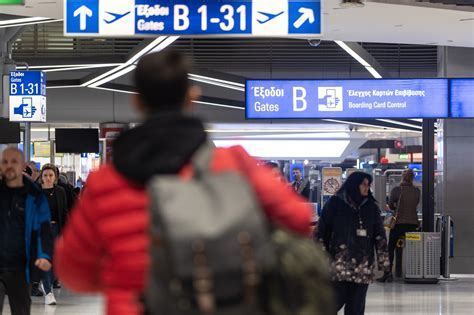 travelers arriving at athens international airport during early spring tourism season
