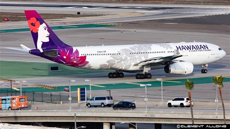 travelers boarding Hawaiian Airlines flight to Honolulu at sunset