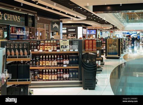 travelers browsing duty-free alcohol aisle before boarding international flight