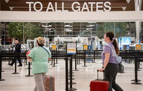 travelers checking flight times amid new united policy june 2025