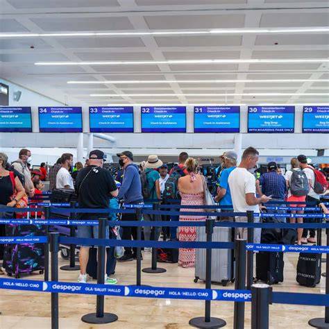 Travelers walking through United Airlines check-in at Chicago O’Hare International Airport with Asia flight displays