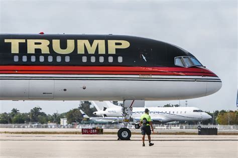 Trump Force One jet on runway with gold logo and tail design