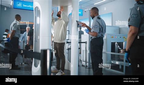 TSA officer screening luggage at airport checkpoint