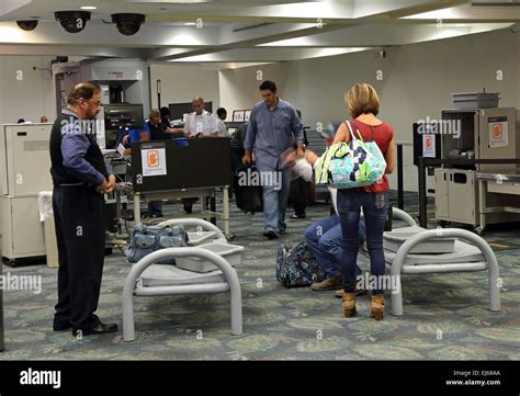 TSA officers conducting airport passenger screening at security checkpoint