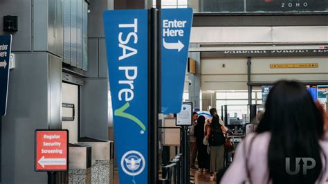 TSA PreCheck signage at busy airport terminal