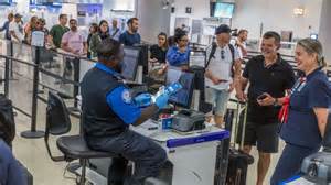 tsa supervisor resolving passenger conflict at security checkpoint