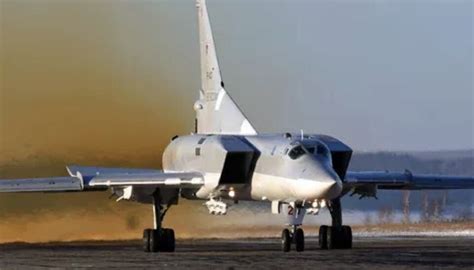 tu-22m3 flying over snow-covered landscape during military exercise