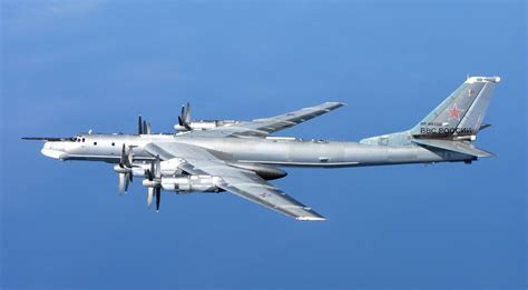 tu-95 bear bomber flying over arctic tundra