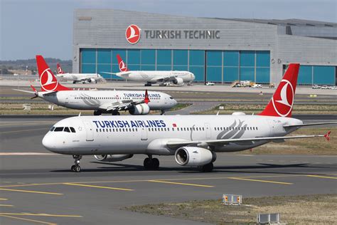 turkish airlines and air europa aircraft side by side at madrid airport apron
