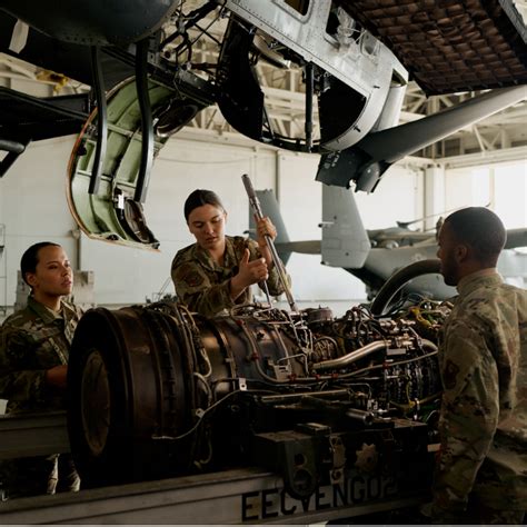 U.S. Air Force mechanics servicing an F-22 Raptor at a maintenance base