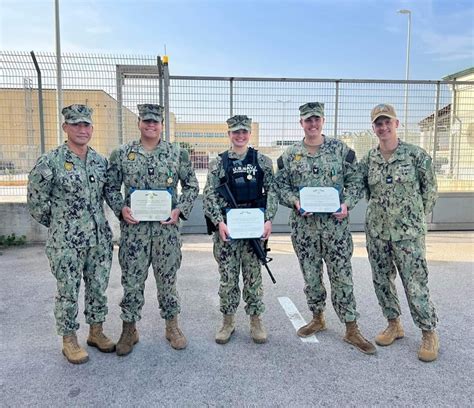 u.s. marine receiving commendation with troops in background at overseas base