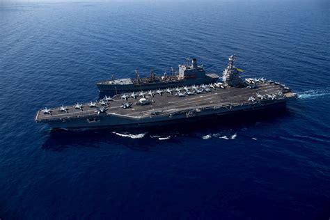 U.S. Navy aircraft carrier deck with multiple Super Hornets in launch configuration