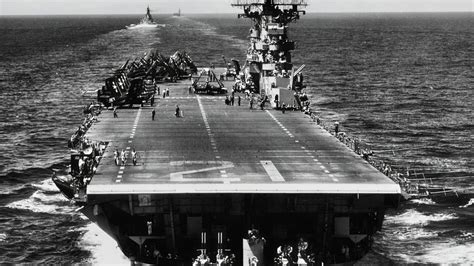 U.S. Navy deck crew working on Essex-class carrier in combat conditions, 1944