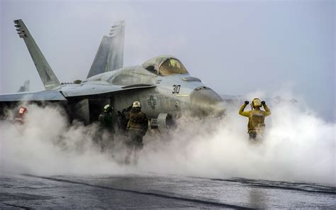 U.S. Navy F/A-18 Hornet preparing for takeoff on an aircraft carrier