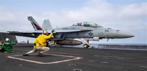 U.S. Navy F/A-18 launching from aircraft carrier deck