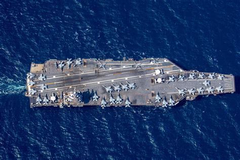 U.S. Navy F/A-18 Super Hornet landing on an aircraft carrier at night