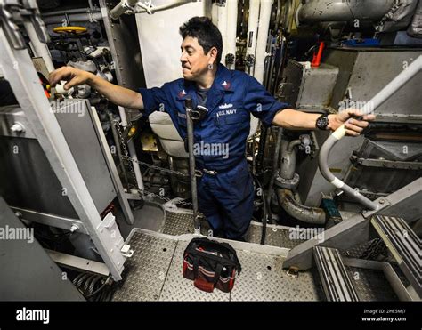 U.S. Navy sailors conducting shipboard maintenance in engineering spaces