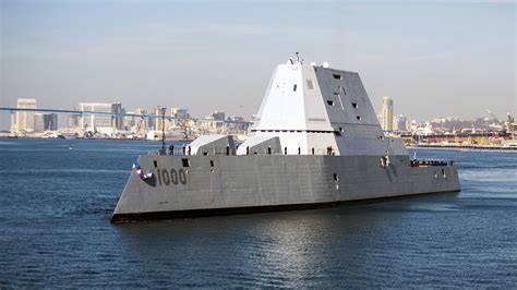 U.S. Navy Zumwalt-class destroyer patrolling Indo-Pacific waters at dusk