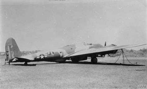 U.S. WWII aircraft with modified insignia showing blue-bordered bars on fuselage