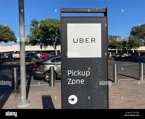Uber driver pickup zone at CDG Terminal 1 with app user waiting