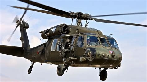 UH-60 Black Hawk helicopter flying over terrain