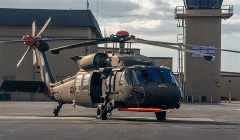 UH-60M Black Hawk formation flight over mixed terrain with varied loadouts