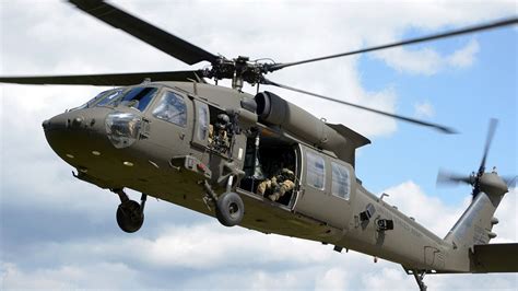 UH-60M during rotor blade alignment inspection in hangar facility