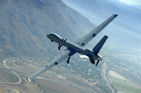 UK Royal Air Force MQ-9 Reaper drone in flight over desert terrain