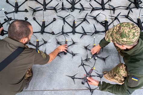 Ukrainian drone engineer assembling FPV drone components on battlefield workbench