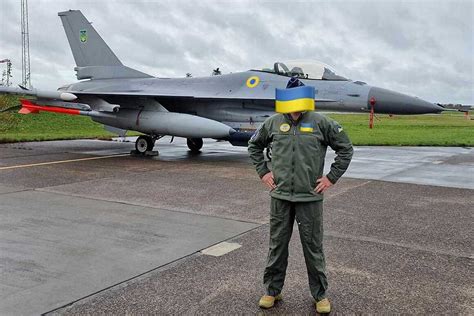 Ukrainian F-16 pilot in full flight gear before simulated sortie in Czech Republic training hangar