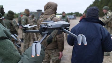 Ukrainian technician assembling an AI-enabled SLAM-guided drone in frontline facility
