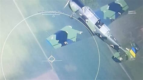 Ukrainian Yak-52 aircraft intercepting reconnaissance drone at sunset