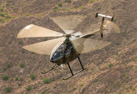 ultrasport 500 helicopter flying low over mountain terrain