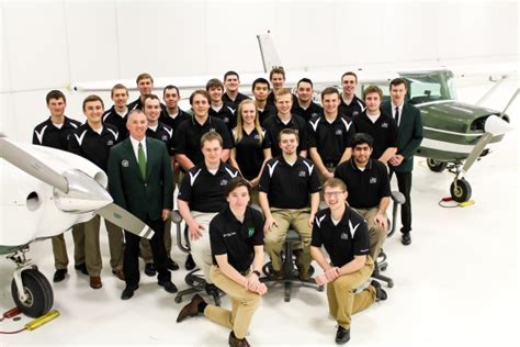 und aviation students gathered in aviation student lounge with flight gear