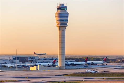 united aircraft lineup at lax international tarmac on sunny day with control tower in background