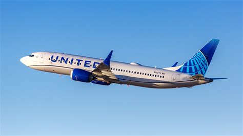 United Airlines Boeing 737 MAX 8 at Glasgow Airport with Scottish terminal backdrop